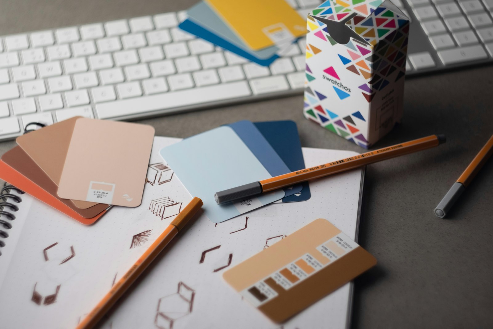 Colour swatches and branding tools on a graphic designer desk