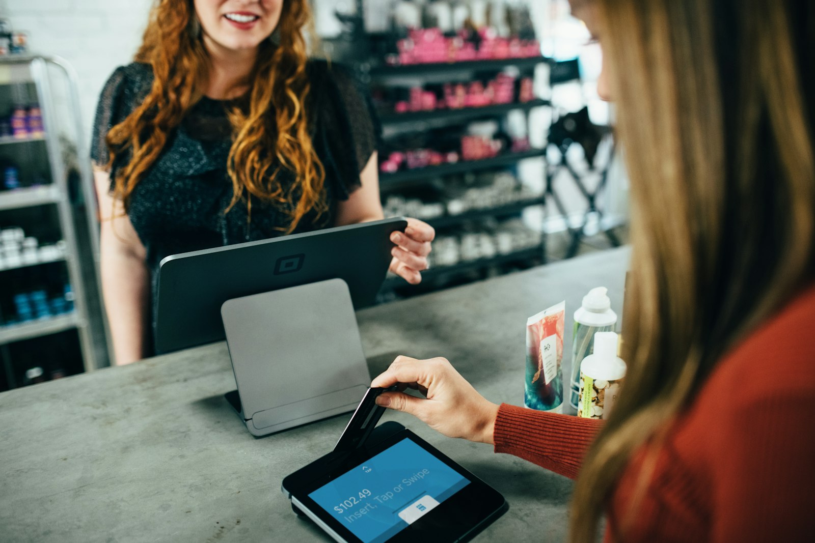 Customer using a payment card at a business payment terminal